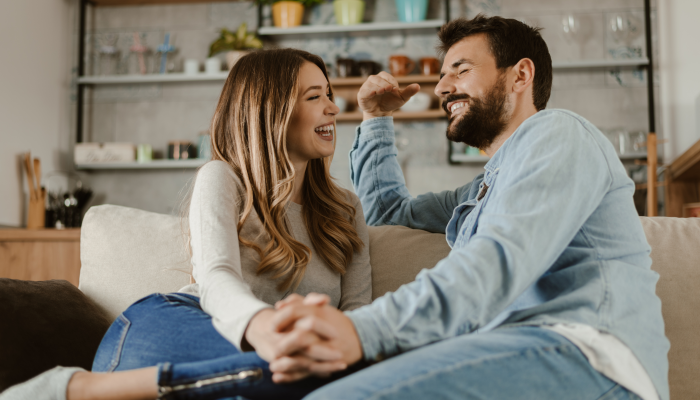 Loving happy couple talking to each other at home.