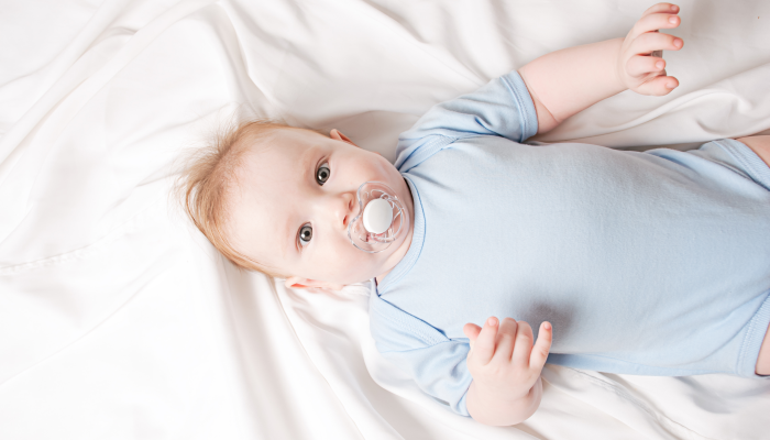 Portrait of a crawling baby on the bed in her room.