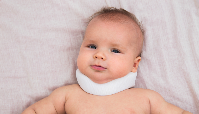 Portrait of baby wearing neck collar.