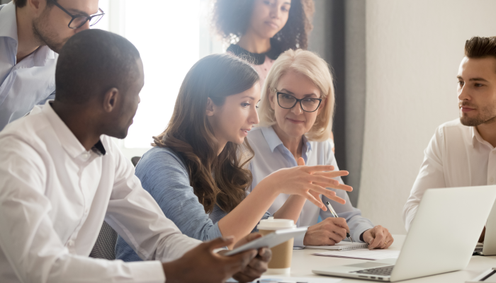 Young female mentor leader coach teaching employees.