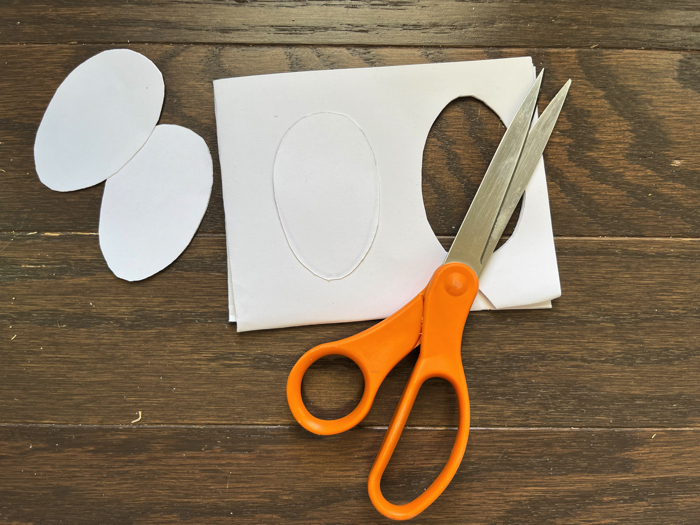 Cutting out eggs for the Easter Egg Greeting Card Craft.