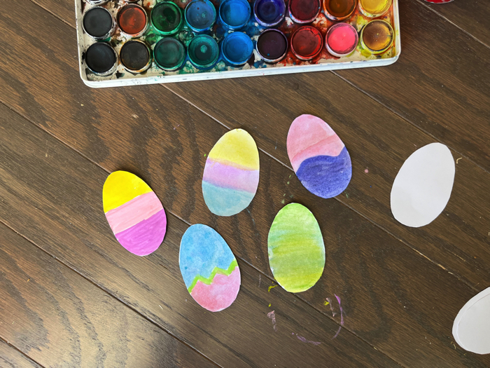 Painting eggs for the Easter Egg Greeting Card Craft.