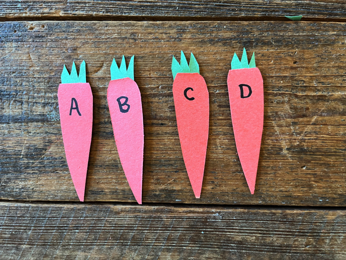 Feed the Bunny Alphabet Game letters on the carrots.