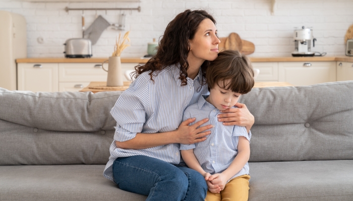 Caring young mom showing support to unhappy offended kid.