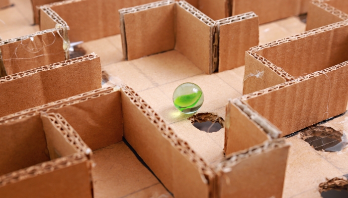 Close up of a handmade card box maze game puzzle.