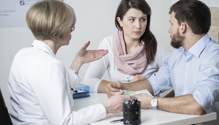 Marriage couple paying for expensive therapy for their child.