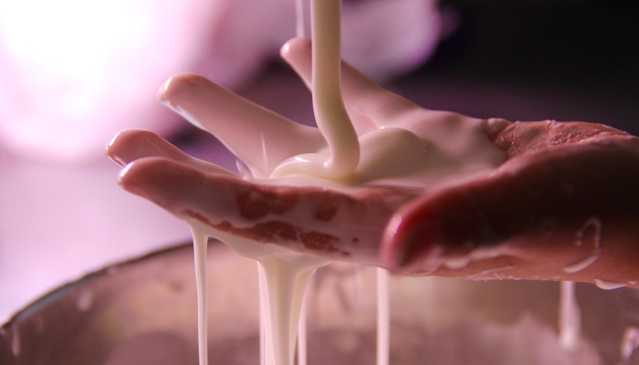 Oobleck running through the hands of a child doing a fun science experiment.