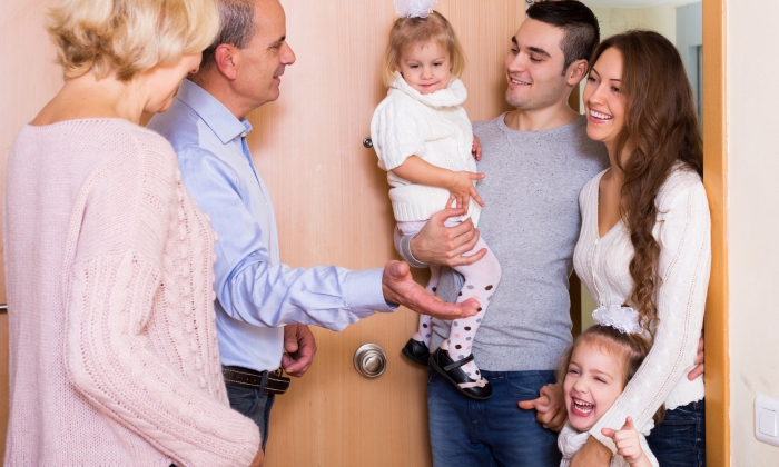 Positive young family with two daughters visiting grand parents.