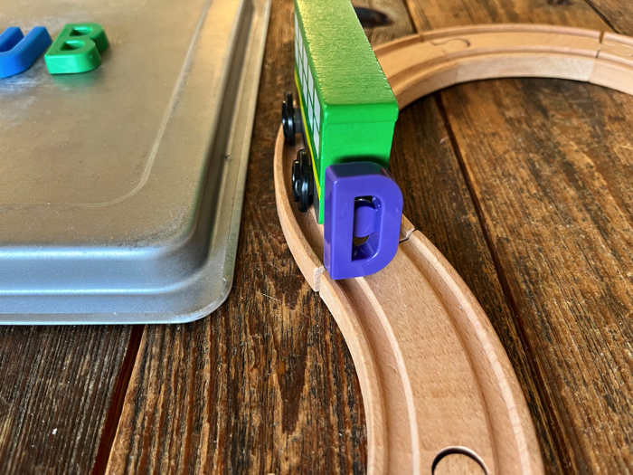 Alphabet Train Activity carrying a letter down the tracks.