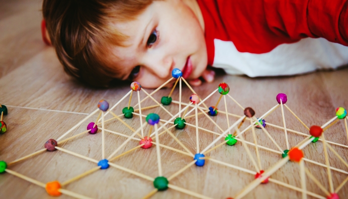 Child making geometric shapes, engineering and STEM.