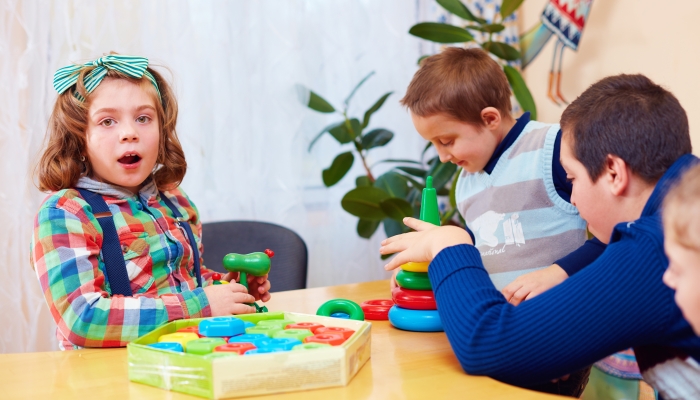 Group of kids playing together in daycare center for kids with special needs.